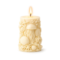 Decorative candle with ocean-themed design on a white background