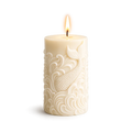 Decorative candle with intricate patterns on a white background