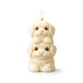 Candle shaped like two stacked puppies on a white background