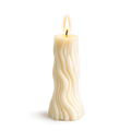 White candle with wavy pattern on a white background