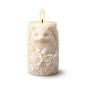 Decorative candle with a hedgehog design on a white background