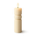 Stacked cylindrical candles with a ribbed texture on a white background