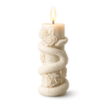 Decorative candle with snake and flower design on a white background