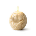 Candle shaped like a dog's head with a lit wick on a white background