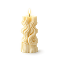 Wavy-patterned candle on a white background