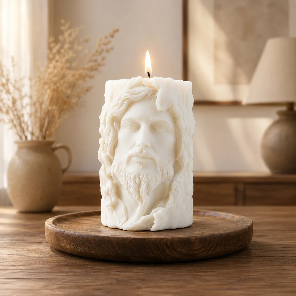 Candle shaped like a face on a wooden tray with a blurred indoor background