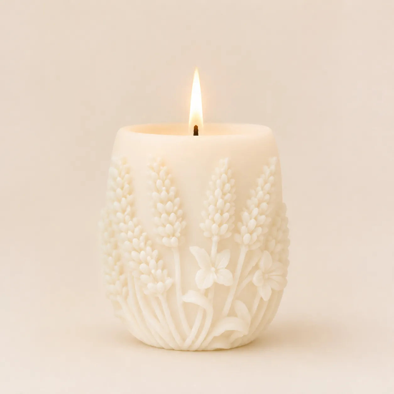 Decorative candle with floral pattern on a beige background
