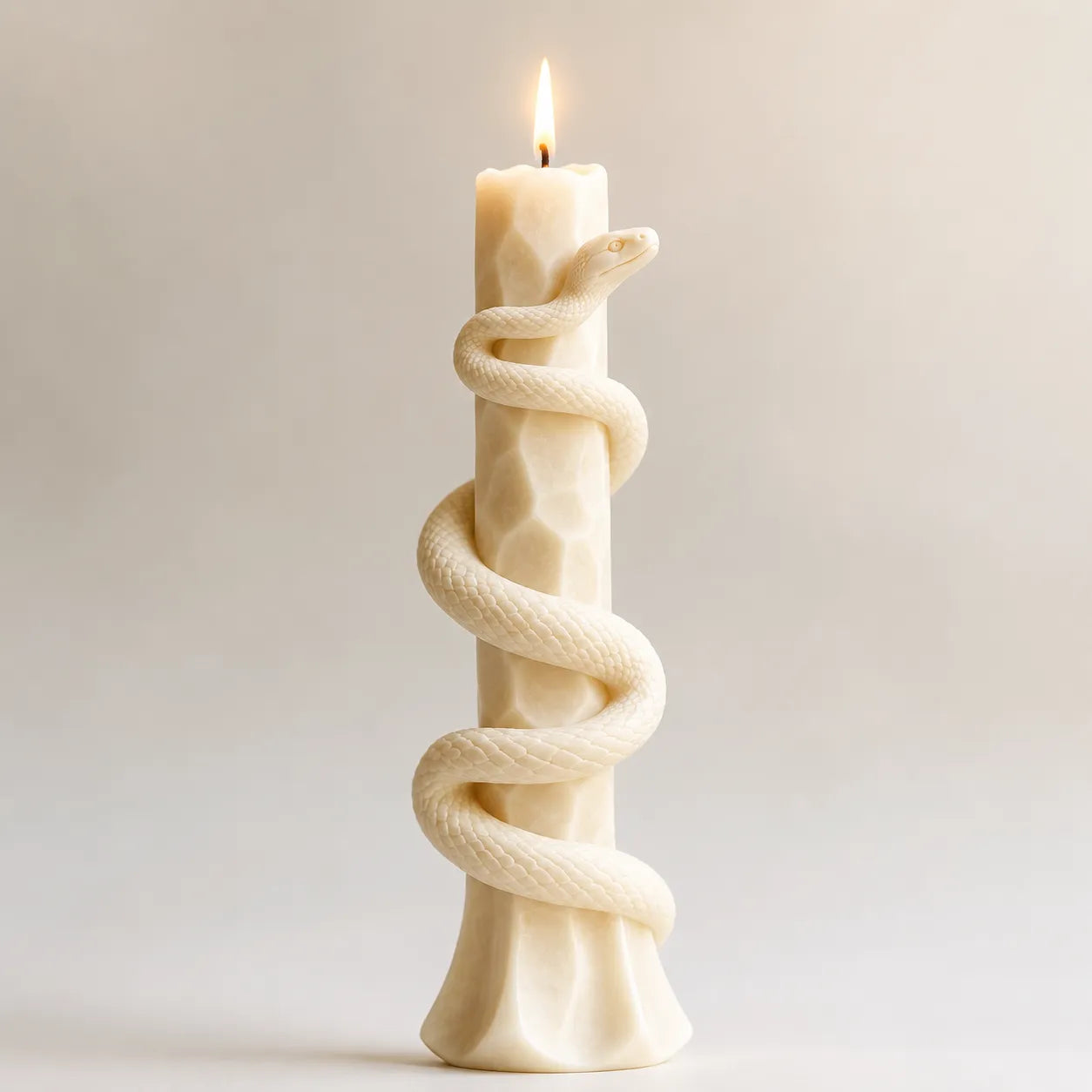 Decorative candle with twisted rope design on a plain background