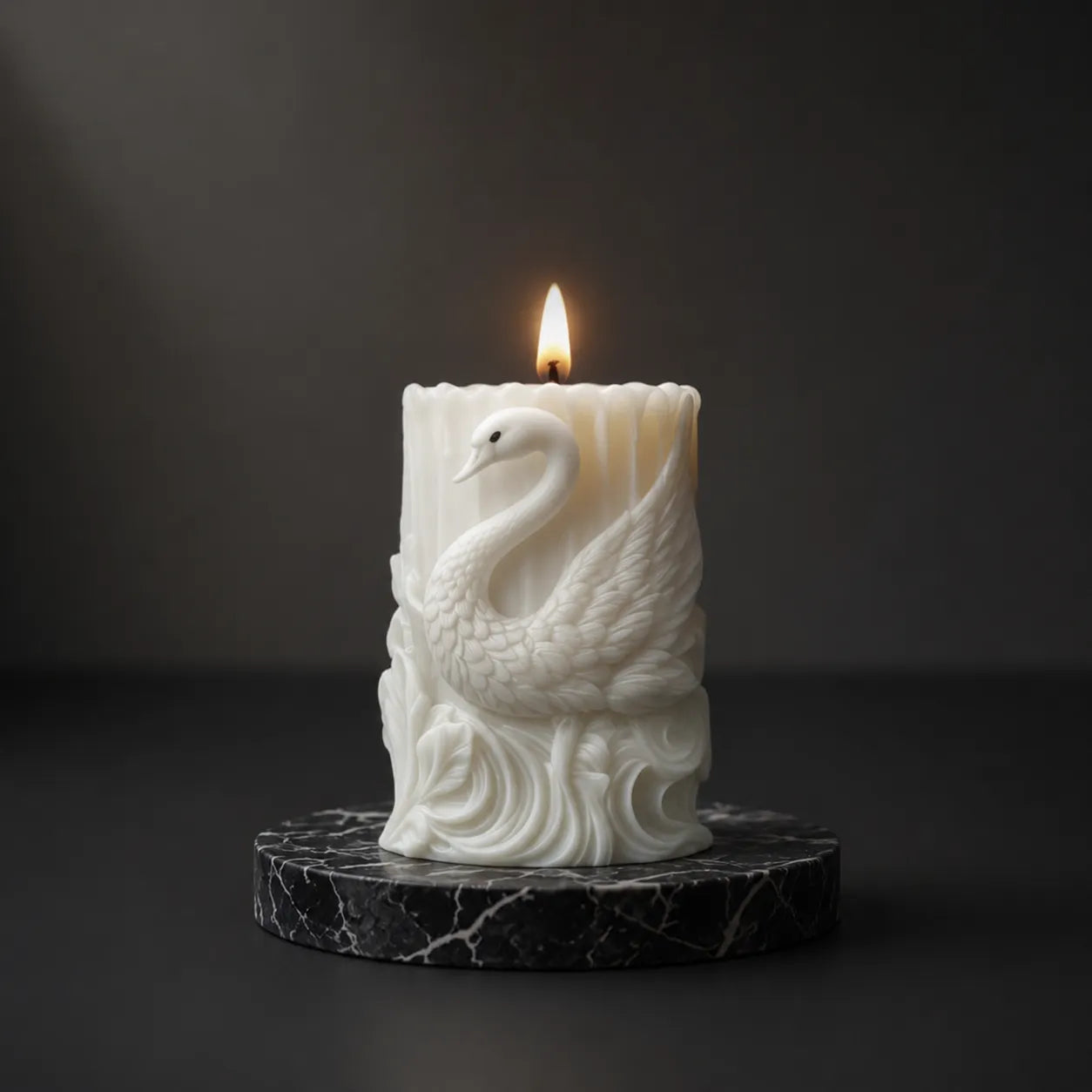 Candle with a swan design on a dark background