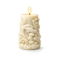 Decorative candle with dolphin and sea creature designs on a white background
