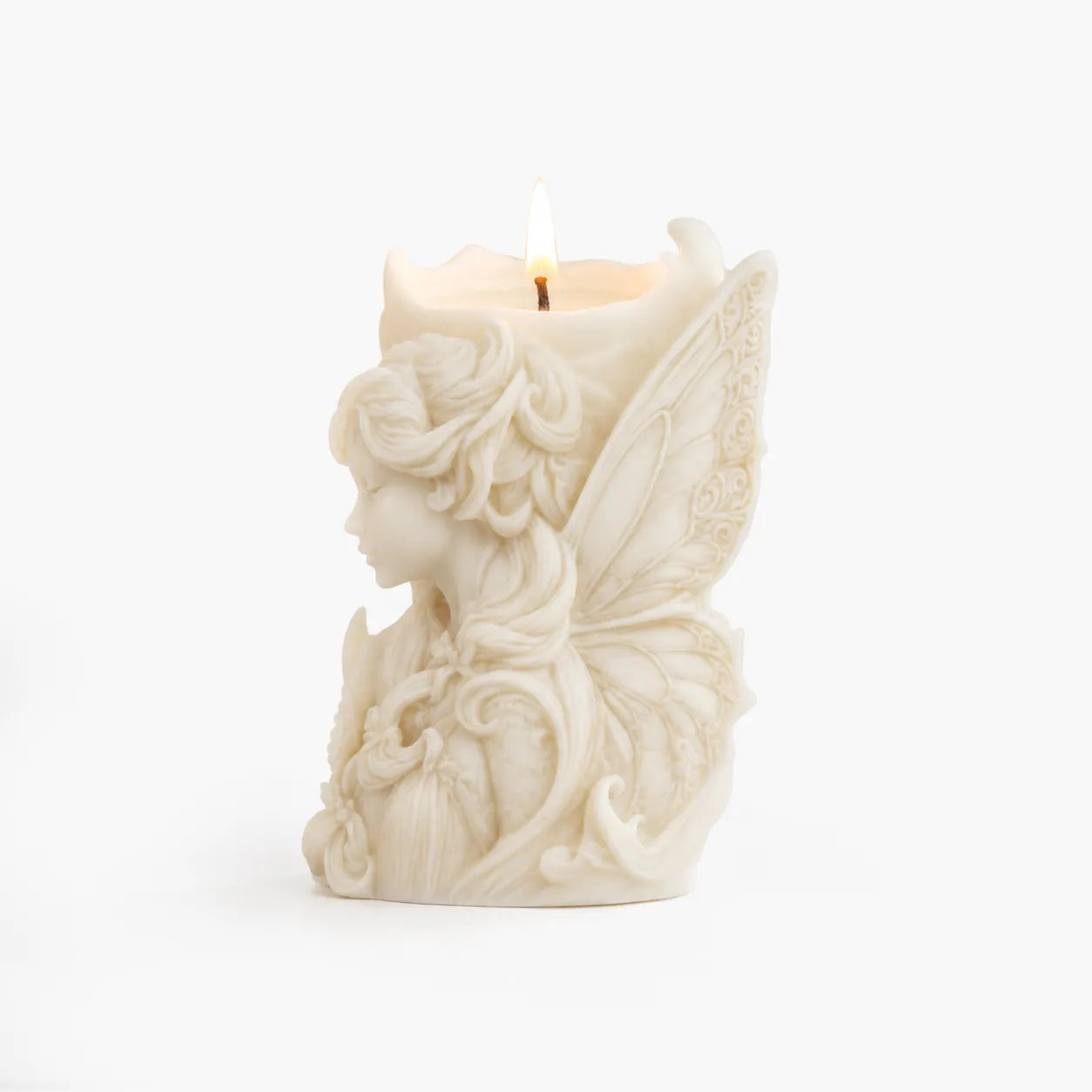 Decorative candle shaped like a fairy with wings on a white background