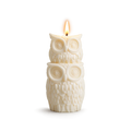 White owl-shaped candle on a white background