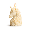 Unicorn-shaped candle with floral details on a white background