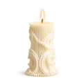 Decorative candle with intricate patterns on a white background