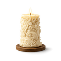 Decorative candle with intricate patterns on a wooden base against a white background