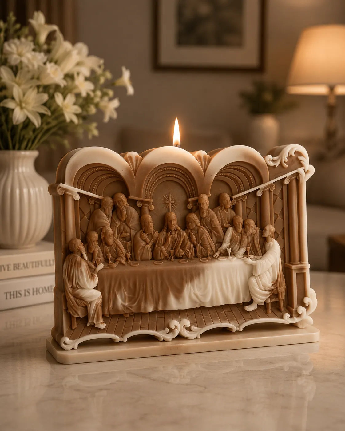 Decorative sculpture of 'The Last Supper' with a candle on a table.